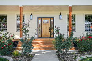 Entrance to property featuring a porch
