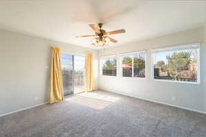 Spare room featuring carpet floors and ceiling fan