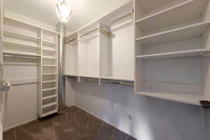 Walk in closet featuring dark colored carpet