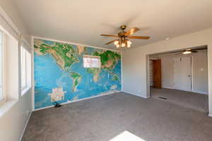 Unfurnished bedroom with carpet and a ceiling fan