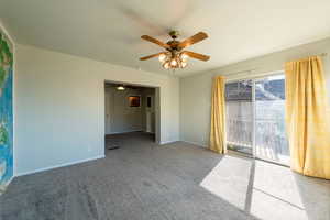 Unfurnished bedroom with access to outside, carpet floors, and a ceiling fan