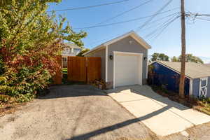 Detached garage featuring concrete driveway