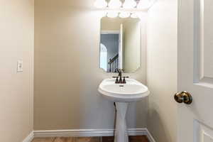 Half bathroom with baseboards and tile patterned floors