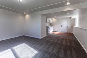 Unfurnished room featuring dark carpet and recessed lighting