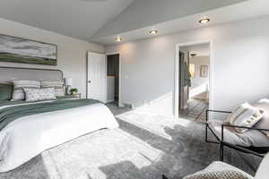 Carpeted bedroom featuring vaulted ceiling and recessed lighting