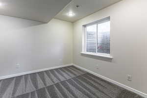 Carpeted empty room with baseboards