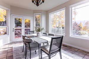 Sunroom / solarium featuring a chandelier
