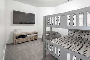 Carpeted bedroom featuring baseboards