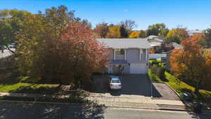 View of front facade featuring driveway and a garage