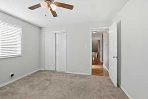 Unfurnished bedroom with carpet flooring, a ceiling fan, and a closet