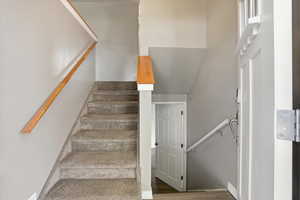 Stairway featuring wood finished floors and baseboards