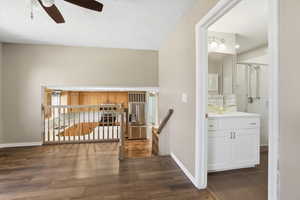 Hall featuring dark wood-type flooring and a textured ceiling