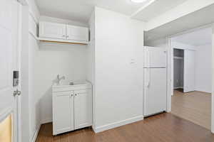 Washroom with dark wood finished floors and a textured ceiling