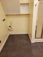 Bathroom featuring a shower stall and baseboards