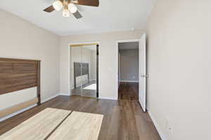 Unfurnished bedroom featuring dark wood finished floors, ceiling fan, and a closet