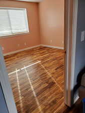 Spare room with light wood-style floors and baseboards