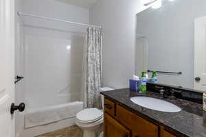Bathroom with vanity and shower / bath combination with curtain