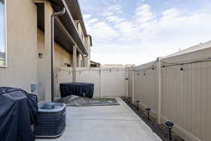 Fenced backyard featuring a patio and a gate