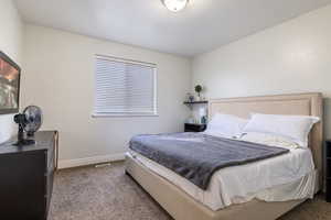 Carpeted bedroom featuring baseboards