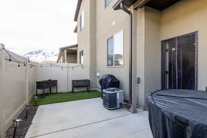Fenced backyard featuring a patio and a mountain view