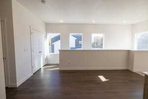 Unfurnished room with dark wood finished floors and recessed lighting