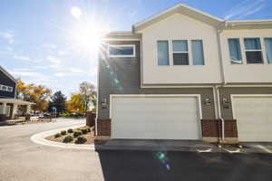 View of property exterior featuring brick siding and stucco siding