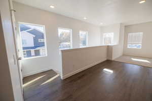 Unfurnished room featuring dark wood-type flooring and recessed lighting