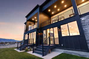 Exterior entry at dusk featuring board and batten siding and a mountain view