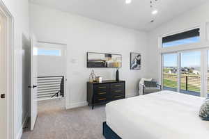 Bedroom featuring light colored carpet, recessed lighting, access to outside, and vaulted ceiling