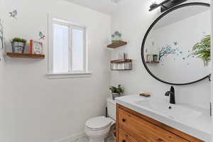 Half bath featuring vanity and light tile patterned floors