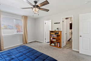 Bedroom featuring light colored carpet and a ceiling fan