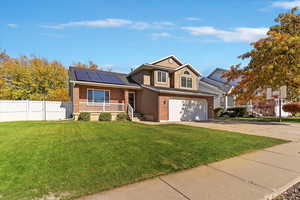 View of front of home with brick siding, a porch, concrete driveway, and an attached garage