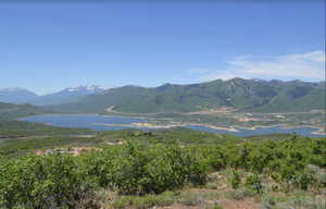 View of mountain backdrop featuring a large body of water