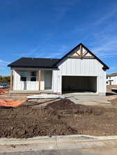 Modern farmhouse with board and batten siding, roof with shingles, a porch, and an attached garage