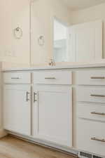 Bathroom with light wood-style flooring and vanity