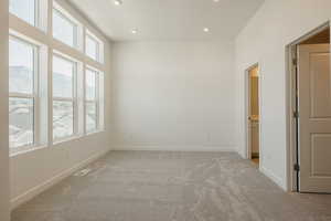 Spare room with light carpet and recessed lighting
