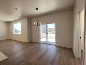 Unfurnished dining area featuring a chandelier, light wood-style floors, and recessed lighting