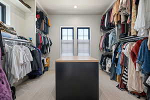 Walk in closet with light carpet
