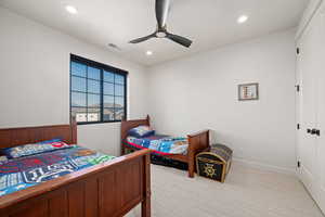 Bedroom with a ceiling fan, light carpet, and recessed lighting