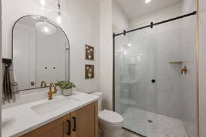 Bathroom featuring vanity and a shower stall