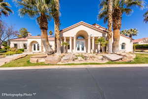 Mediterranean / spanish house with french doors, stucco siding, a tile roof, and a chimney