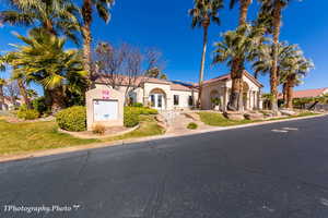 View of front of property featuring stucco siding and a front lawn