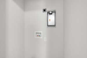 Washroom with hookup for a washing machine and hookup for an electric dryer