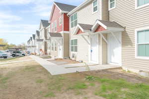 View of home's exterior featuring a residential view and a shingled roof