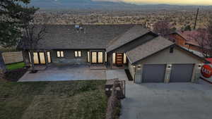 View of front of home featuring a shingled roof, driveway, a garage, and stucco siding