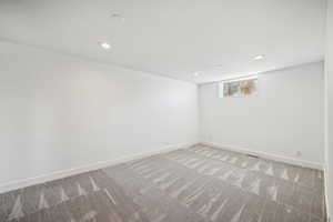 Unfurnished room with light carpet and recessed lighting