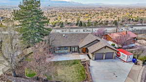 Aerial view of property and surrounding area featuring a mountain backdrop