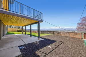 Fenced backyard with a patio area and a mountain view