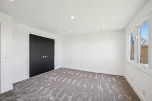 Unfurnished bedroom featuring recessed lighting, carpet, and a closet