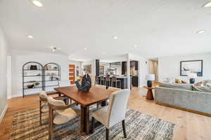 Dining area with recessed lighting and light wood-style floors